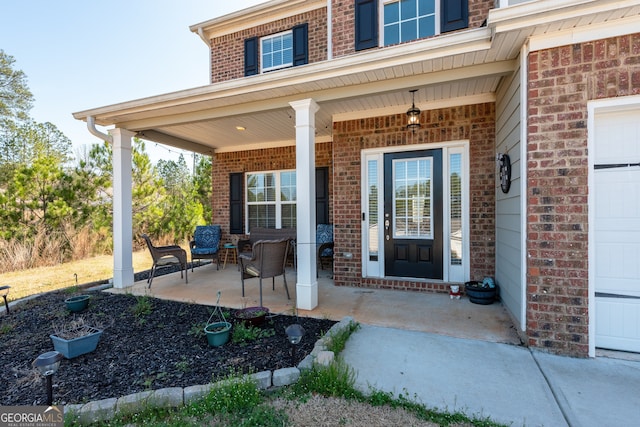 property entrance featuring a garage and a porch