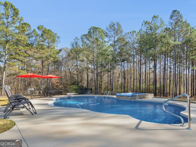 view of swimming pool featuring a diving board, a patio area, and an in ground hot tub