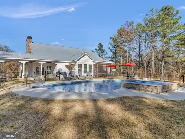 view of swimming pool featuring a patio area, a yard, and a hot tub