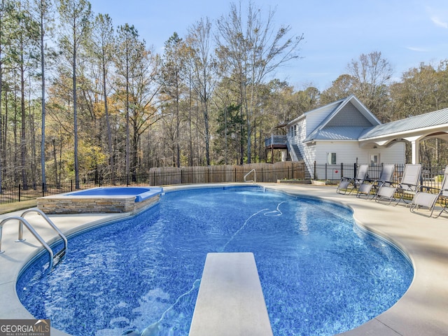 view of pool featuring a diving board and a patio