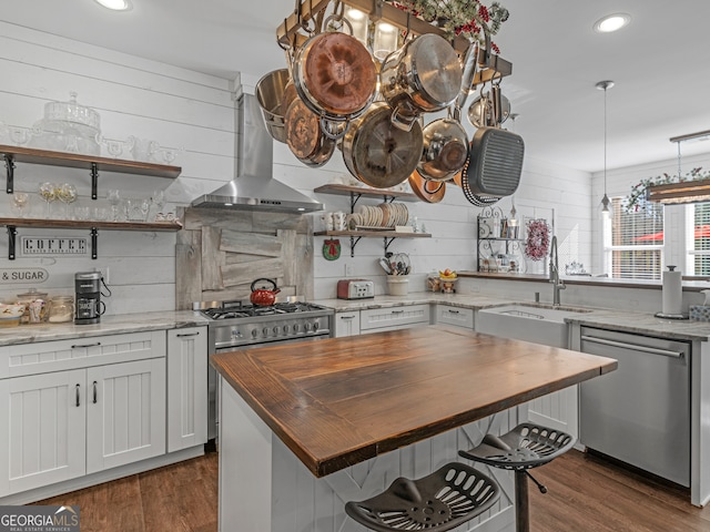 kitchen featuring dark wood-type flooring, light stone countertops, and stainless steel dishwasher