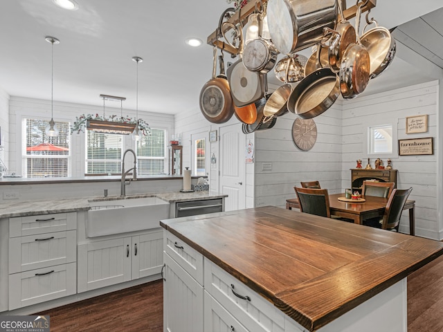 kitchen featuring a healthy amount of sunlight, a kitchen island, and butcher block countertops