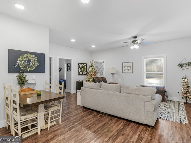 living room with ceiling fan and dark hardwood / wood-style floors