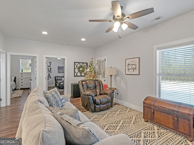 living room featuring hardwood / wood-style floors and ceiling fan