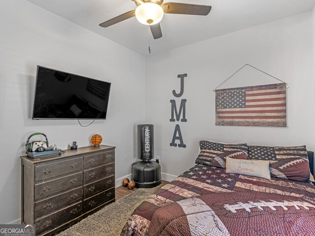 bedroom featuring wood-type flooring and ceiling fan