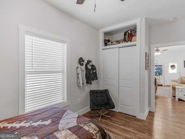 bedroom with ceiling fan, hardwood / wood-style floors, and a closet