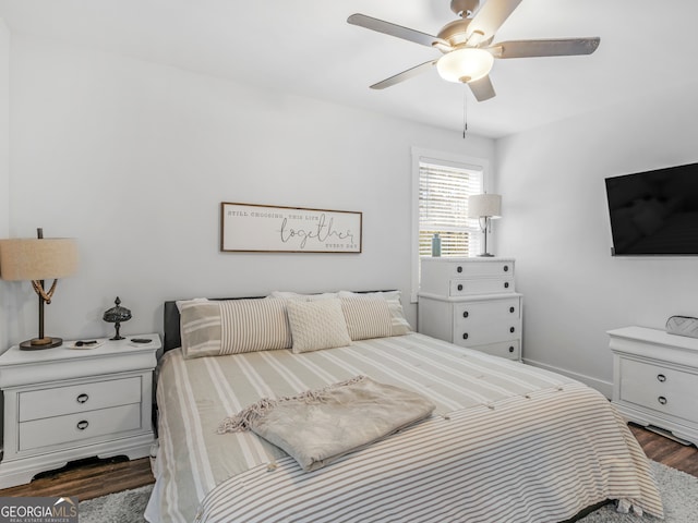 bedroom with ceiling fan and dark hardwood / wood-style floors