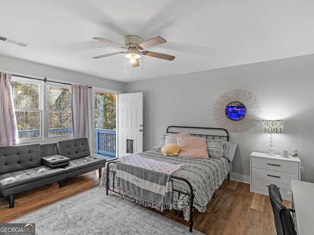 bedroom with ceiling fan, wood-type flooring, and access to outside