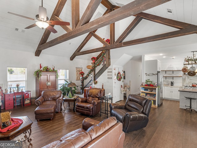 living room featuring ceiling fan, dark hardwood / wood-style floors, and beam ceiling