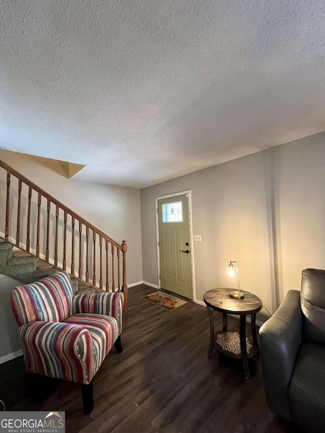 foyer with dark hardwood / wood-style floors and a textured ceiling