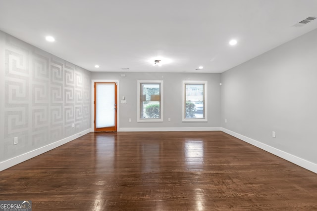 unfurnished room with dark wood-type flooring