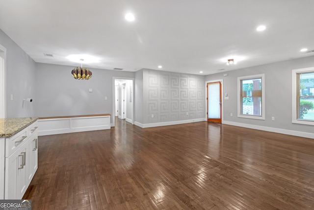 unfurnished living room with dark hardwood / wood-style flooring