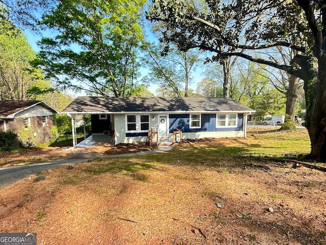 ranch-style home with a front yard and a carport