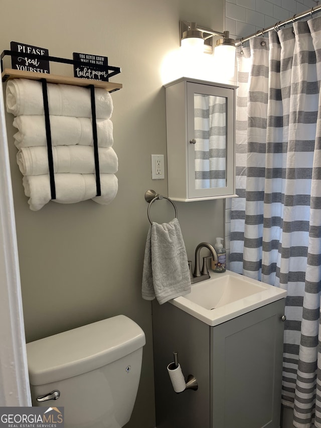 bathroom featuring vanity and toilet