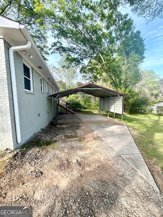 view of side of property featuring a yard and a carport