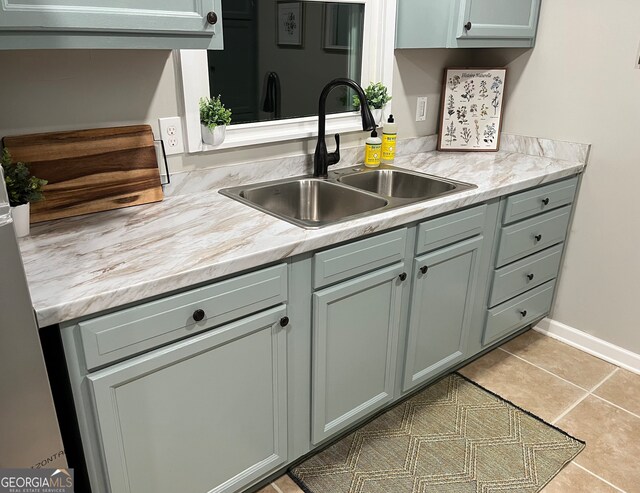 kitchen featuring light tile patterned floors and sink