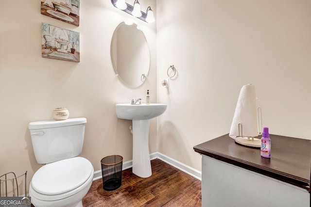 bathroom featuring hardwood / wood-style flooring, sink, and toilet