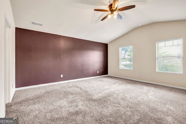 carpeted empty room featuring lofted ceiling and ceiling fan