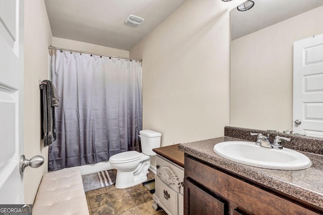 bathroom with an enclosed shower, vanity, and toilet