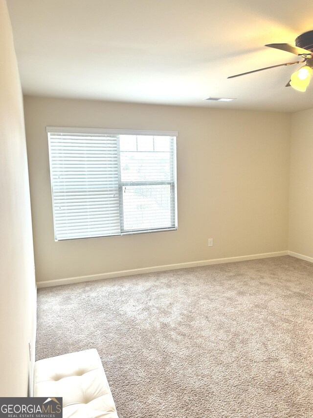 corridor featuring light colored carpet