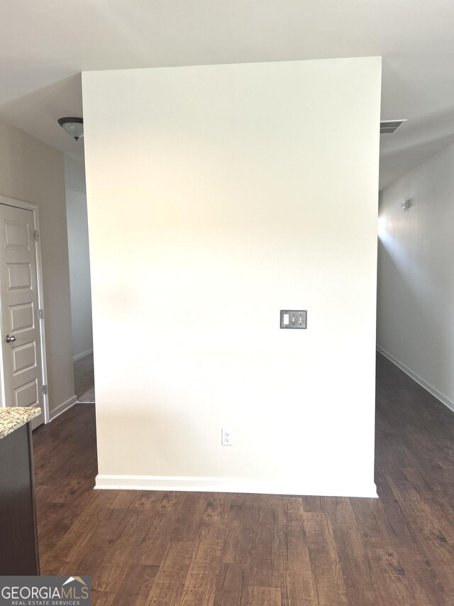 unfurnished dining area featuring hardwood / wood-style floors and a chandelier