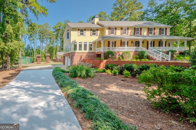 3060 Orchard Rd SW, Conyers, GA 30094 - view of front of home with driveway, a chimney, a shed, an attached garage, and a porch