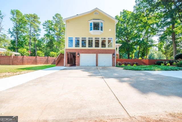 3060 Orchard Rd SW, Conyers, GA 30094 - view of front facade with stairs, brick siding, driveway, and a garage