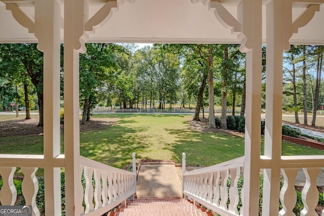 3060 Orchard Rd SW, Conyers, GA 30094 - view of green lawn with covered porch and view of wooded area