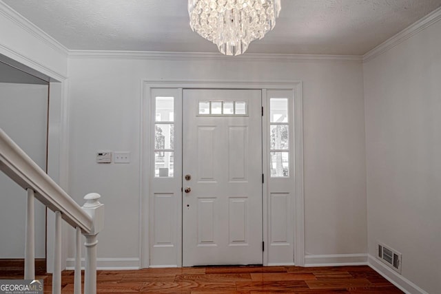 3060 Orchard Rd SW, Conyers, GA 30094 - foyer entrance with wood finished floors, a chandelier, crown molding, and stairway