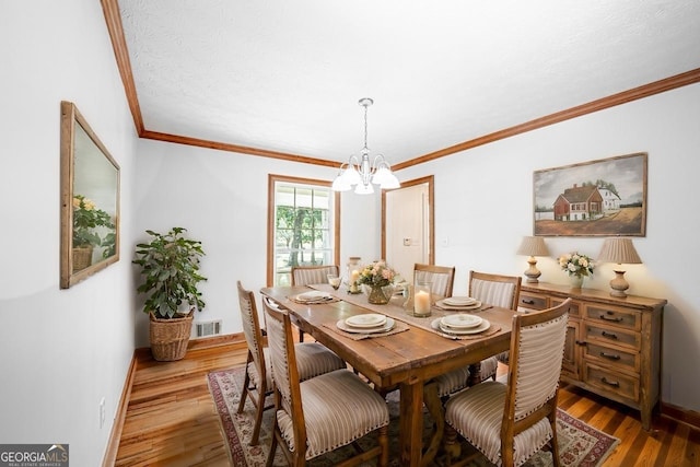 3060 Orchard Rd SW, Conyers, GA 30094 - dining room featuring a chandelier, wood finished floors, and crown molding