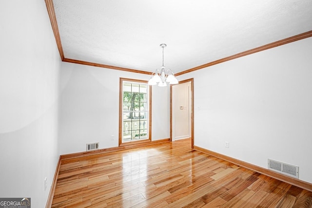 3060 Orchard Rd SW, Conyers, GA 30094 - unfurnished room with a chandelier, light wood-type flooring, and ornamental molding