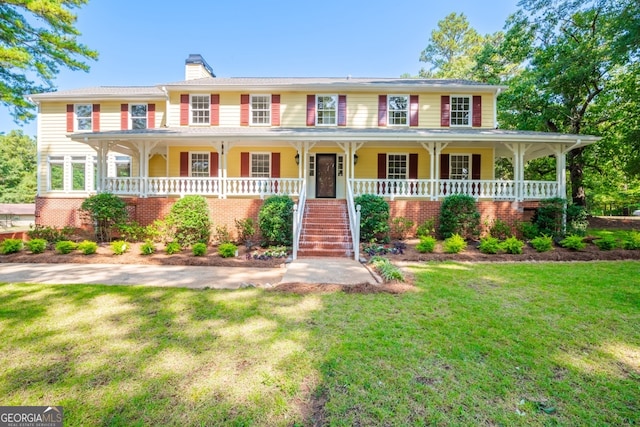 view of front facade featuring a front yard and covered porch