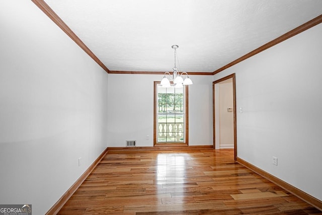 3060 Orchard Rd SW, Conyers, GA 30094 - spare room with a chandelier, wood finished floors, and crown molding