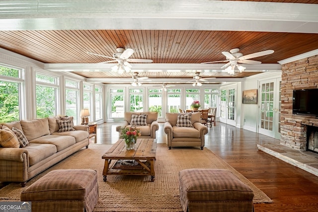 living room featuring hardwood / wood-style floors, a stone fireplace, ceiling fan, wooden ceiling, and french doors