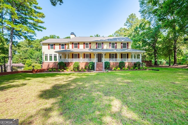 colonial home featuring a front lawn and a porch