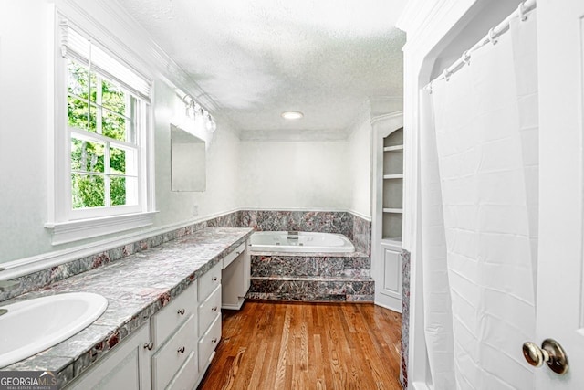 3060 Orchard Rd SW, Conyers, GA 30094 - full bath with vanity, a textured ceiling, wood finished floors, a garden tub, and crown molding