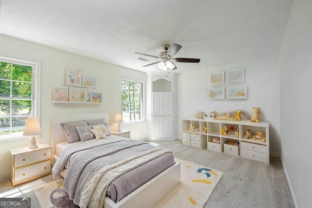 3060 Orchard Rd SW, Conyers, GA 30094 - bedroom with multiple windows, carpet floors, a ceiling fan, and a textured ceiling