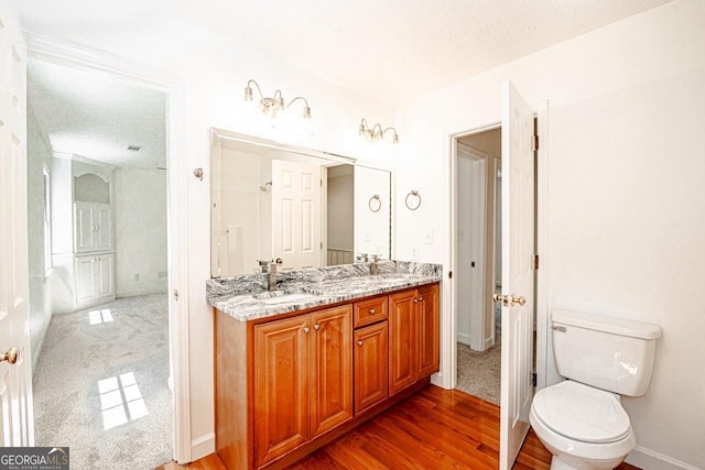 3060 Orchard Rd SW, Conyers, GA 30094 - bathroom with double vanity, wood finished floors, and a textured ceiling