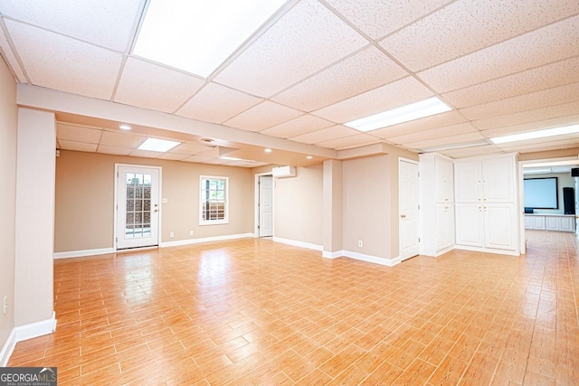 3060 Orchard Rd SW, Conyers, GA 30094 - spare room featuring a paneled ceiling, a wall mounted AC, and light wood-style floors