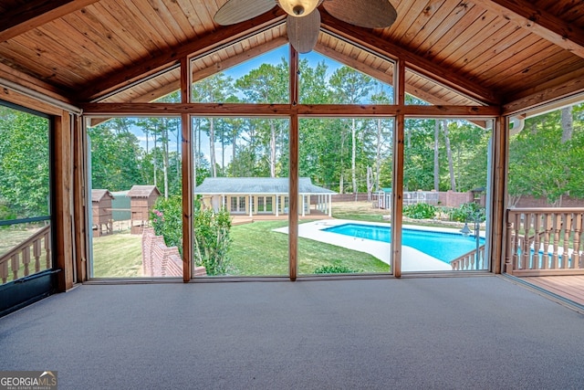 unfurnished sunroom with wood ceiling, vaulted ceiling, and ceiling fan