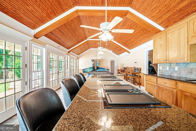 kitchen with decorative backsplash, wood ceiling, ceiling fan, and a breakfast bar area