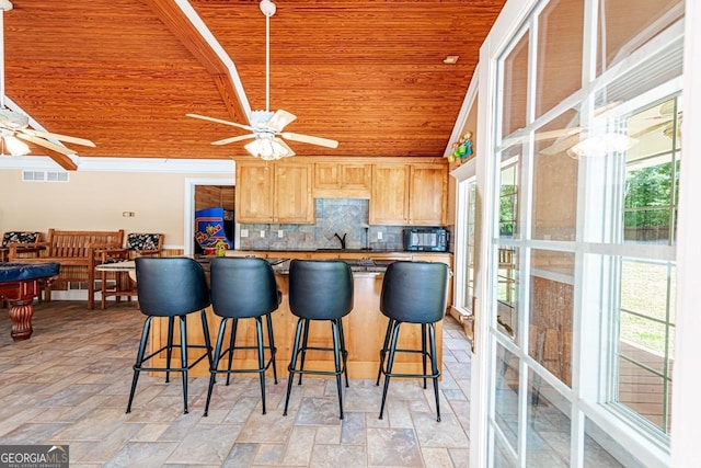 3060 Orchard Rd SW, Conyers, GA 30094 - kitchen featuring wood ceiling, ceiling fan, decorative backsplash, and a kitchen breakfast bar