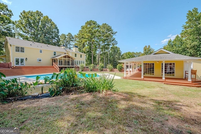 3060 Orchard Rd SW, Conyers, GA 30094 - view of green lawn with a sunroom, a deck, and french doors