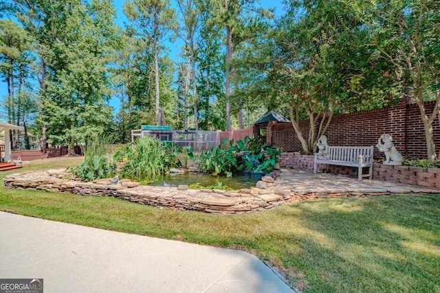 3060 Orchard Rd SW, Conyers, GA 30094 - view of yard featuring a patio and a garden pond