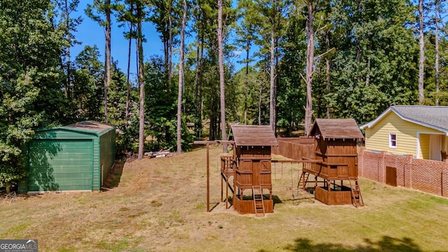 view of yard featuring a playground and a storage shed