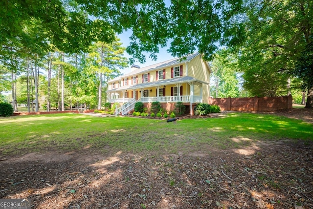 view of front of house with a front yard and covered porch