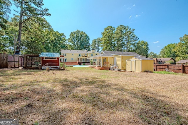 3060 Orchard Rd SW, Conyers, GA 30094 - back of house with a shed, a fenced backyard, and a wooden deck