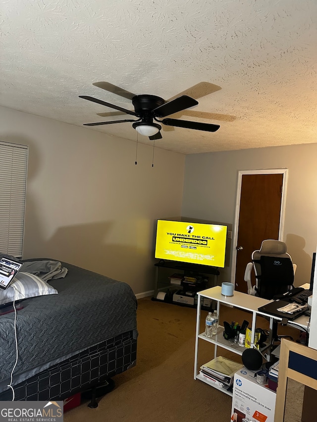 carpeted bedroom with a textured ceiling and ceiling fan