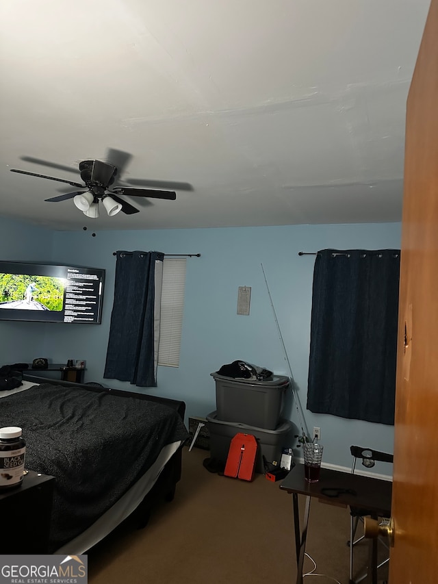 bedroom featuring ceiling fan and carpet