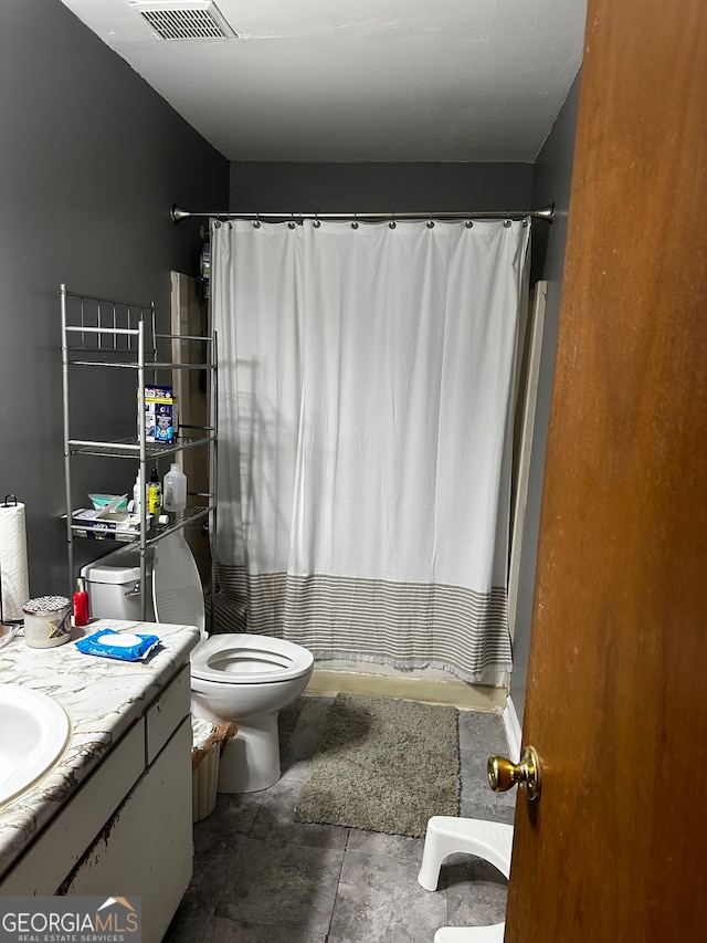 full bathroom featuring toilet, vanity, and shower / bathtub combination with curtain